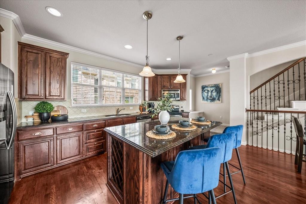 2700 Club Ridge Drive, Unit 34 Lewisville, TX 75067 - Photo 10 of 27 a kitchen with granite countertop a dining table chairs stainless steel appliances and cabinets