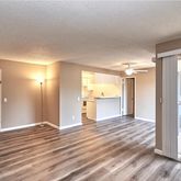 a view of a big room with wooden floor and door