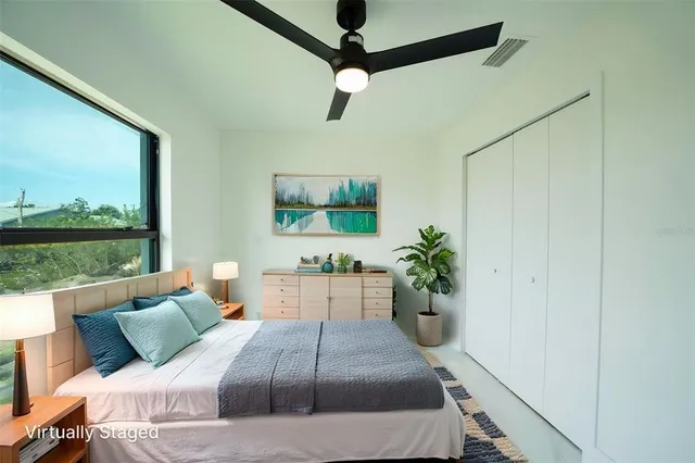 a view of a livingroom with workspace and a window