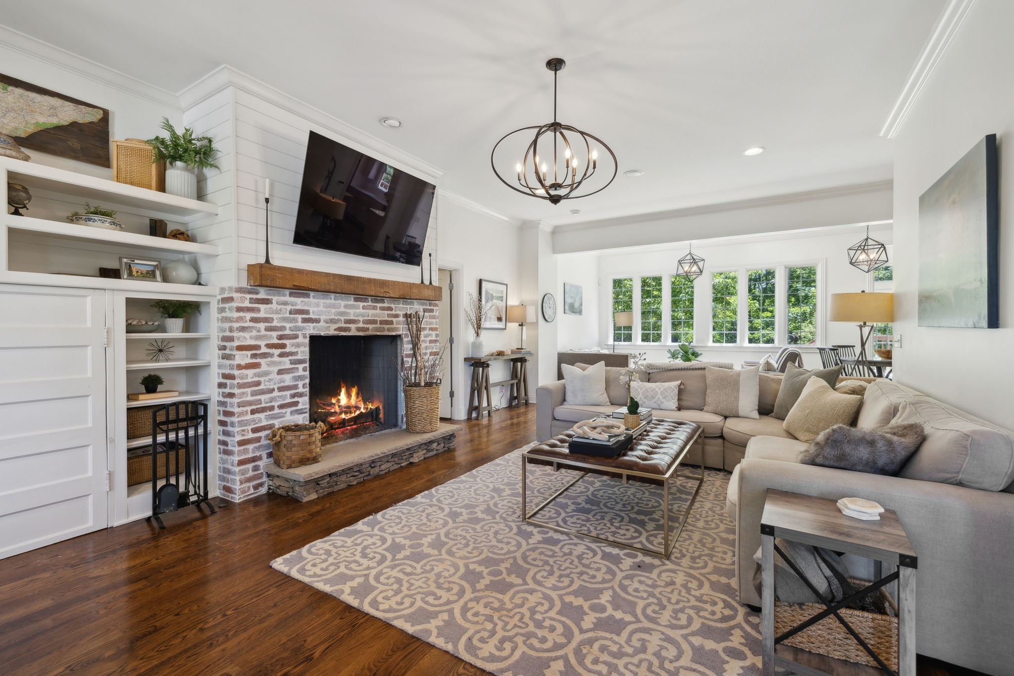 6795 Leipers Creek Road Columbia, TN 38401 - Photo 32 of 98 a living room with furniture a fireplace and a flat screen tv