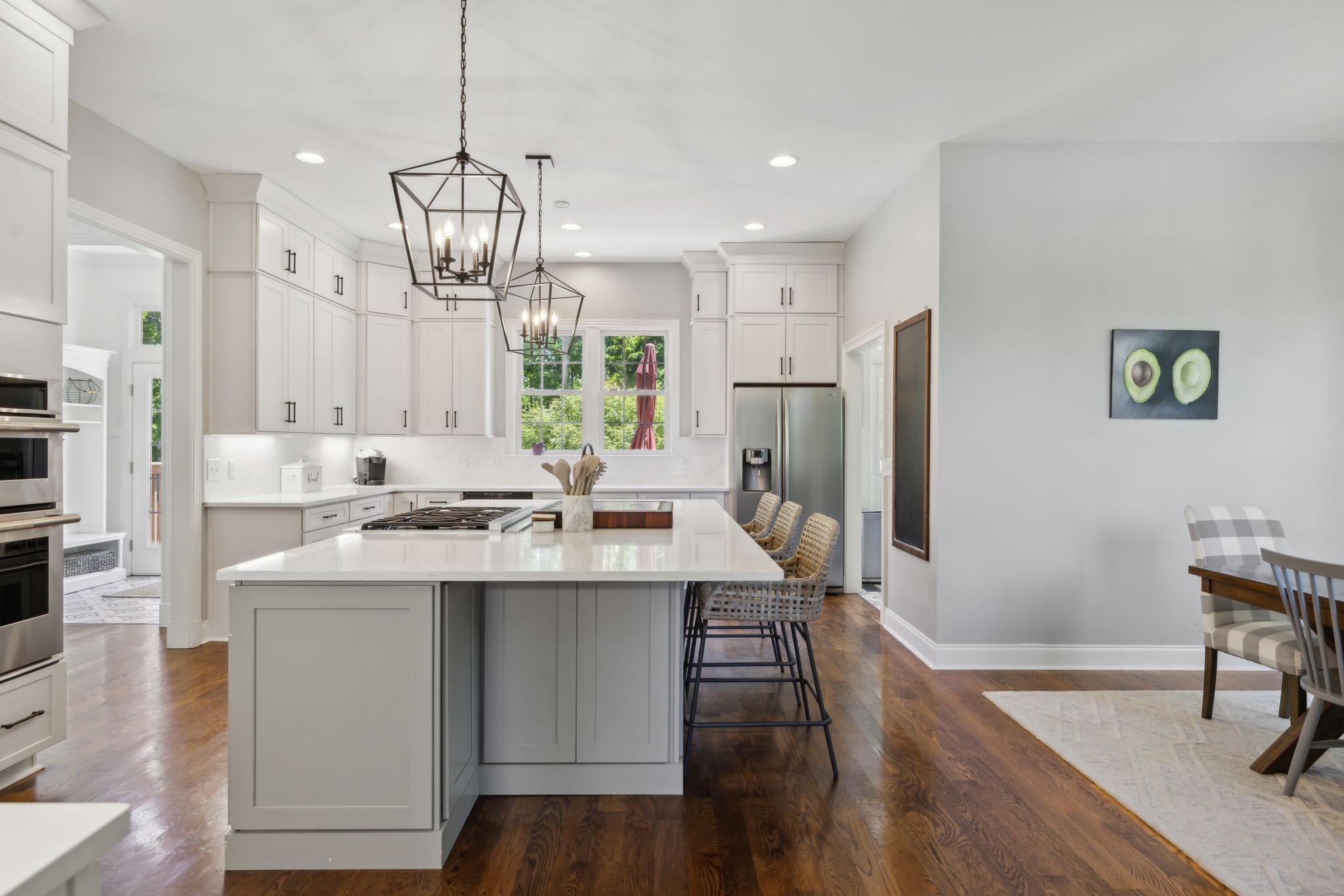 6795 Leipers Creek Road Columbia, TN 38401 - Photo 54 of 98 a kitchen with stainless steel appliances a dining table chairs refrigerator and cabinets
