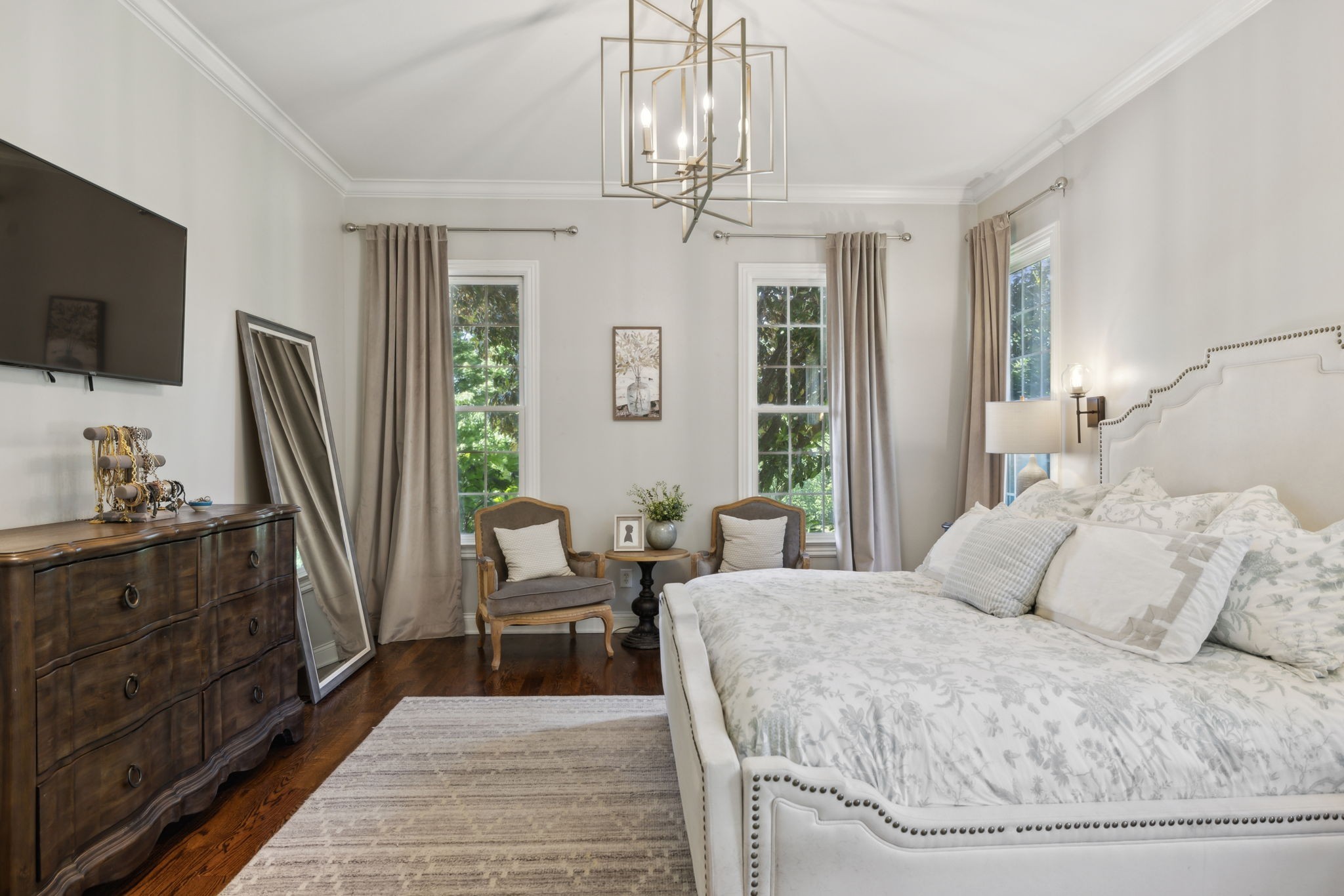 6795 Leipers Creek Road Columbia, TN 38401 - Photo 62 of 98 a bedroom with a large bed a flat tv screen and a dresser