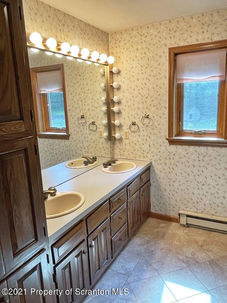 2480 Madisonville Road Moscow, PA 18444 - Photo 15 of 22 a bathroom with a sink a vanity and a mirror