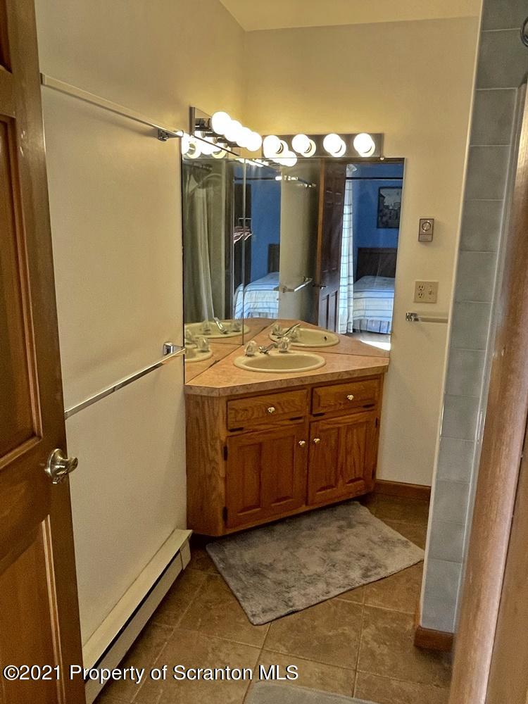 2480 Madisonville Road Moscow, PA 18444 - Photo 19 of 22 a bathroom with a sink and a mirror