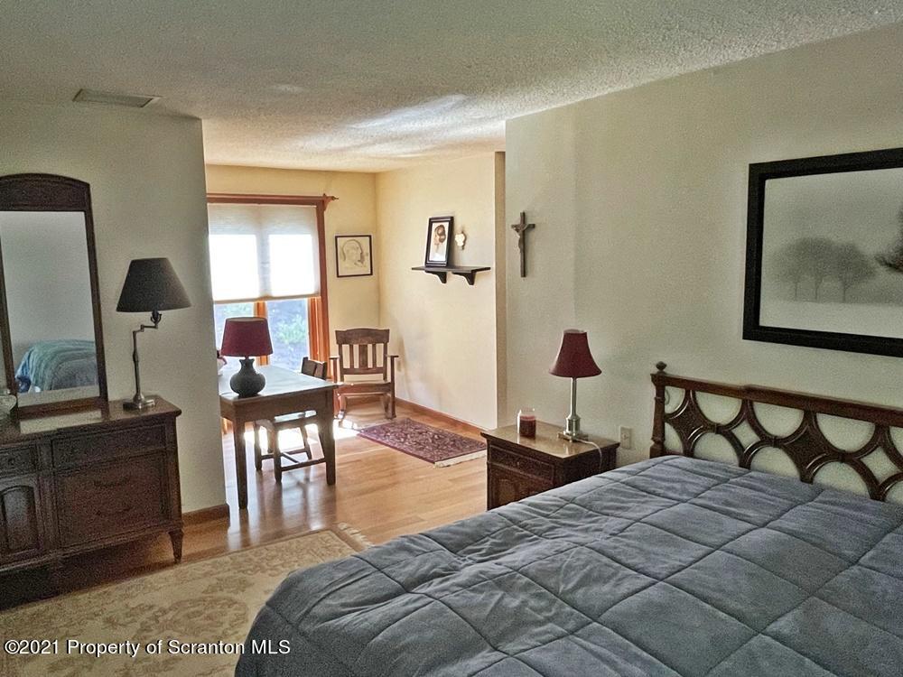 2480 Madisonville Road Moscow, PA 18444 - Photo 21 of 22 a bedroom with a bed and a dresser in it