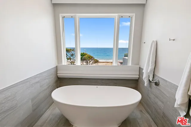 a spacious bathroom with a granite countertop sink mirror and shower