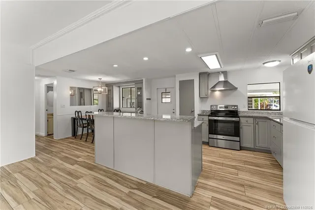 a kitchen with a refrigerator and a counter top space