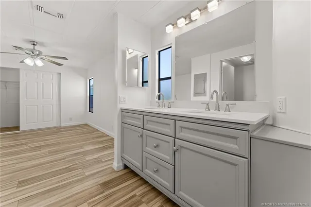 a bathroom with a sink double vanity and a mirror