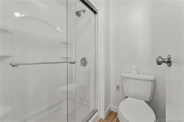 a bathroom with a toilet and a shower