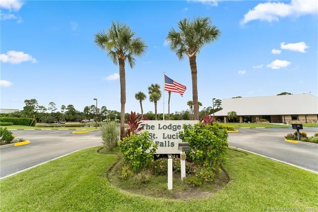 a view of a swimming pool with a patio and a garden