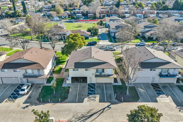 a aerial view of a house with a garden and lake view