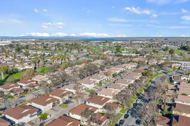 an aerial view of residential houses with outdoor space