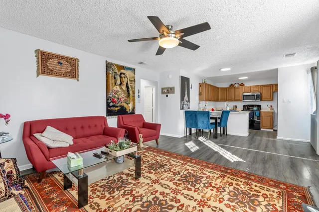 a living room with a couch and a view of kitchen