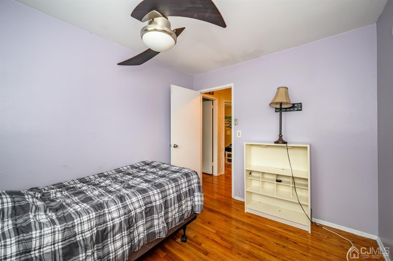 11 Atlantic Road Somerset, NJ 08873 - Photo 14 of 35 a bedroom with a bed and a chandelier