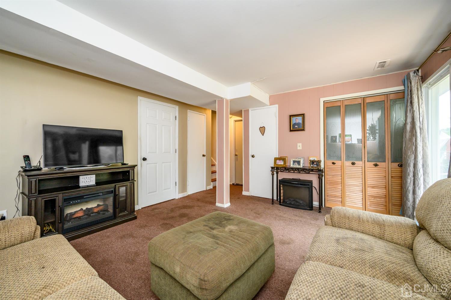 11 Atlantic Road Somerset, NJ 08873 - Photo 23 of 35 a living room with furniture and a flat screen tv