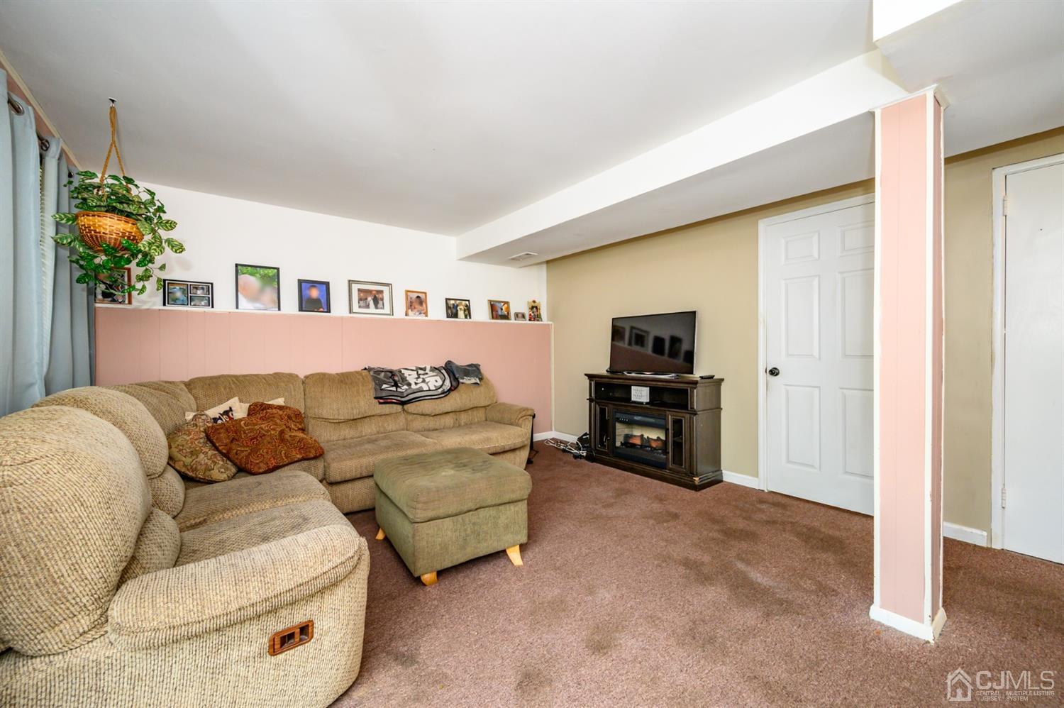 11 Atlantic Road Somerset, NJ 08873 - Photo 24 of 35 a living room with furniture and a flat screen tv