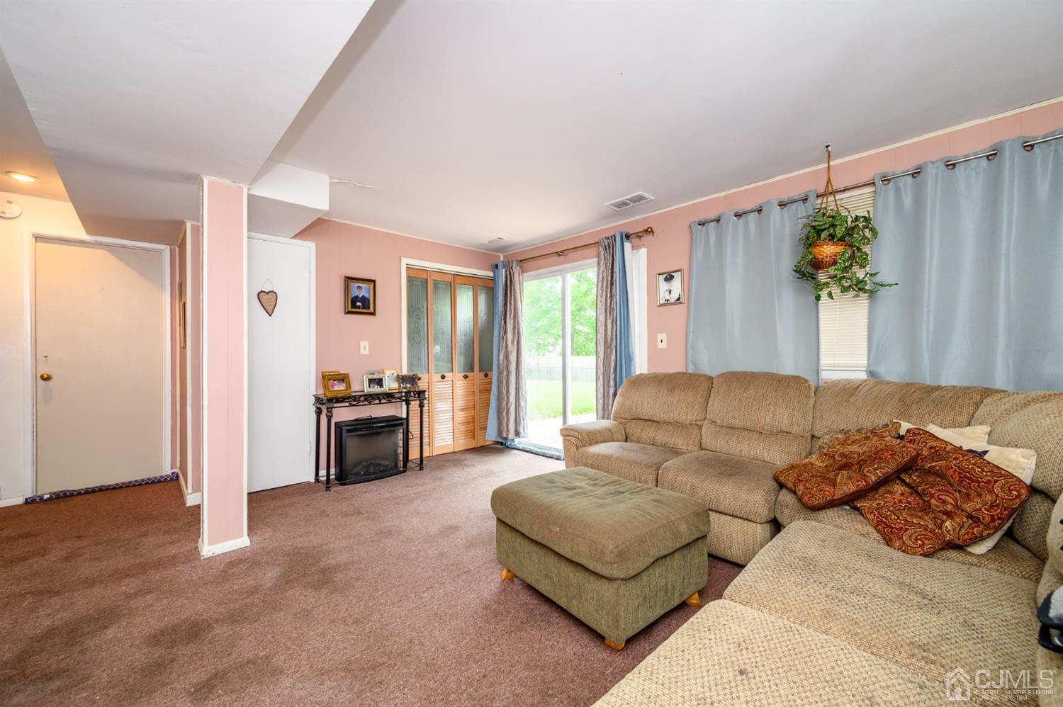 11 Atlantic Road Somerset, NJ 08873 - Photo 25 of 35 a living room with furniture a fireplace and a flat screen tv