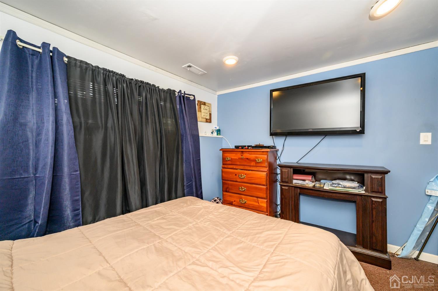 11 Atlantic Road Somerset, NJ 08873 - Photo 28 of 35 a bedroom with a bed and a flat screen tv