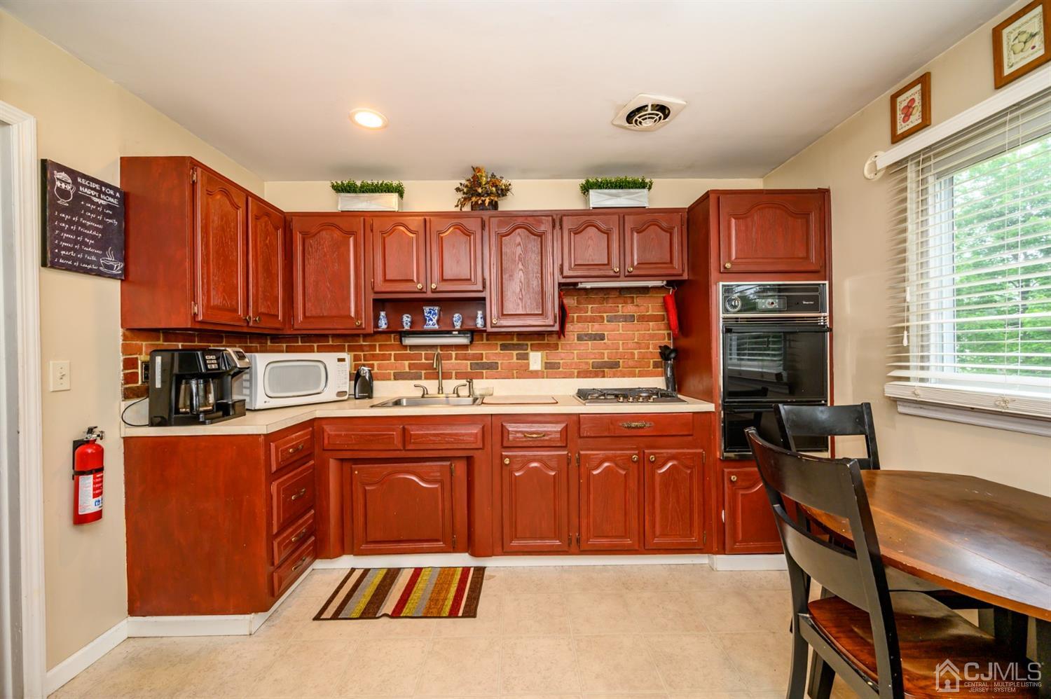 11 Atlantic Road Somerset, NJ 08873 - Photo 10 of 35 a kitchen with stainless steel appliances granite countertop a stove top oven a sink dishwasher and cabinets