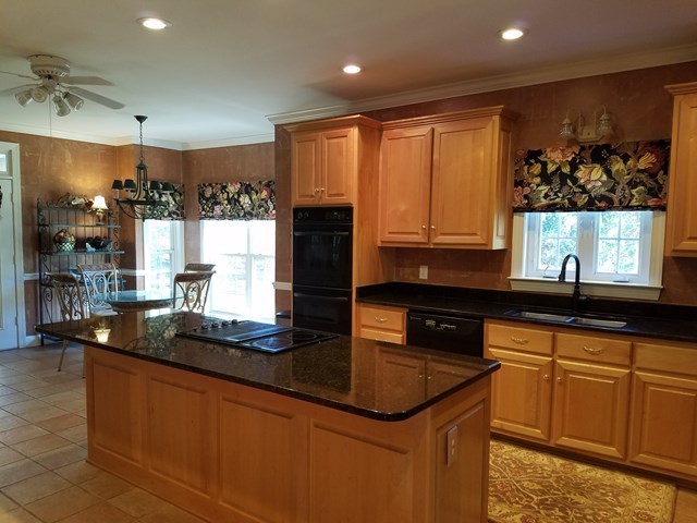 722 Bass Road Macon, GA 31210 - Photo 12 of 40 a kitchen with granite countertop a sink a stove and cabinets