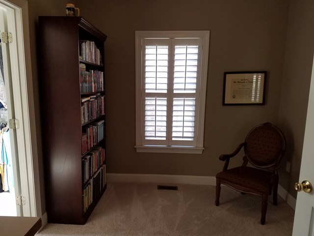 722 Bass Road Macon, GA 31210 - Photo 21 of 40 a living room with furniture a bookshelf and a window