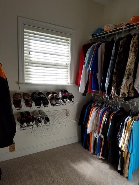 722 Bass Road Macon, GA 31210 - Photo 23 of 40 a view of walk in closet with clothes and shoes