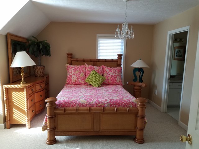 722 Bass Road Macon, GA 31210 - Photo 27 of 40 a bedroom with a bed and a chandelier