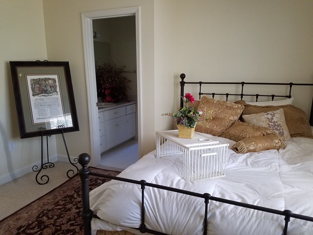 722 Bass Road Macon, GA 31210 - Photo 30 of 40 a bedroom with a bed and a flat tv screen on the dresser