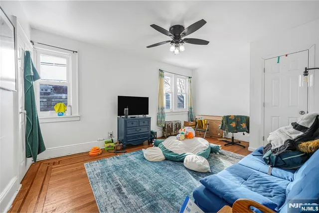 a bedroom with furniture and a flat screen tv