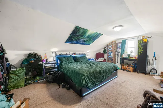 a bed room with a bed a mirror and dresser