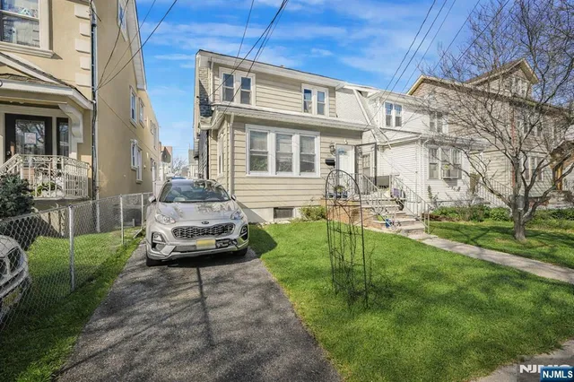 a car parked in front of a brick house