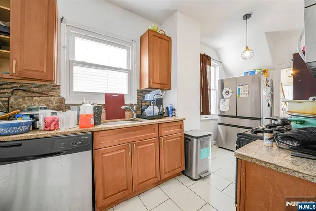 a kitchen with a sink stove and cabinets