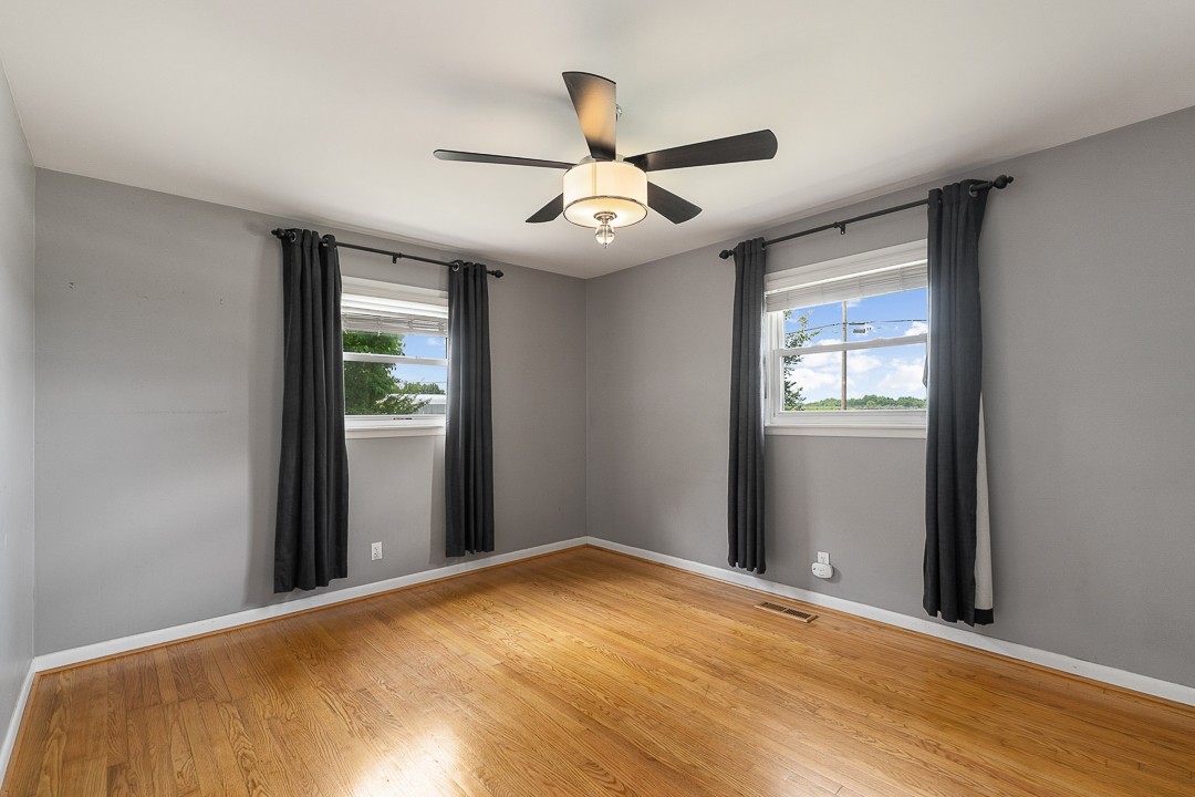 1823 Evins Mill Road Smithville, TN 37166 - Photo 11 of 19 an empty room with windows and a ceiling fan