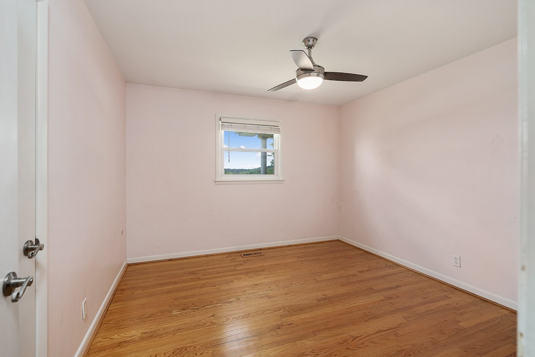 1823 Evins Mill Road Smithville, TN 37166 - Photo 14 of 19 wooden floor in an empty room with a window