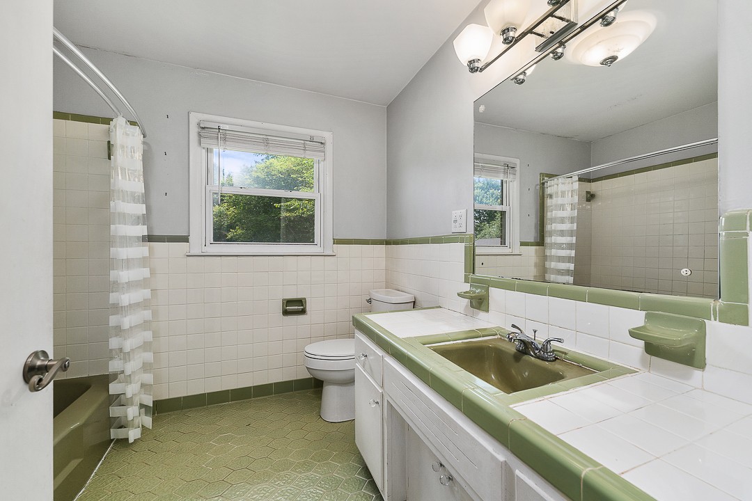 1823 Evins Mill Road Smithville, TN 37166 - Photo 15 of 19 a bathroom with a sink a toilet and a mirror