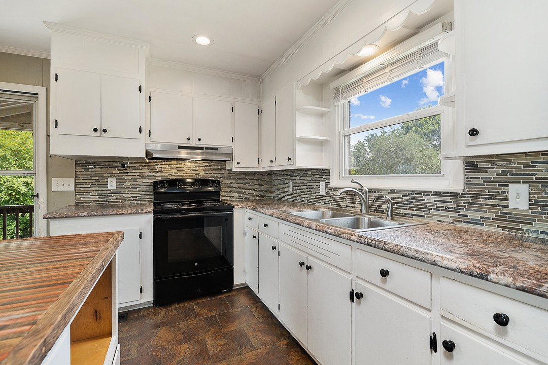1823 Evins Mill Road Smithville, TN 37166 - Photo 4 of 19 a kitchen with granite countertop a sink stove and cabinets