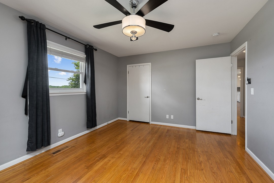 1823 Evins Mill Road Smithville, TN 37166 - Photo 10 of 19 a view of empty room with wooden floor and fan