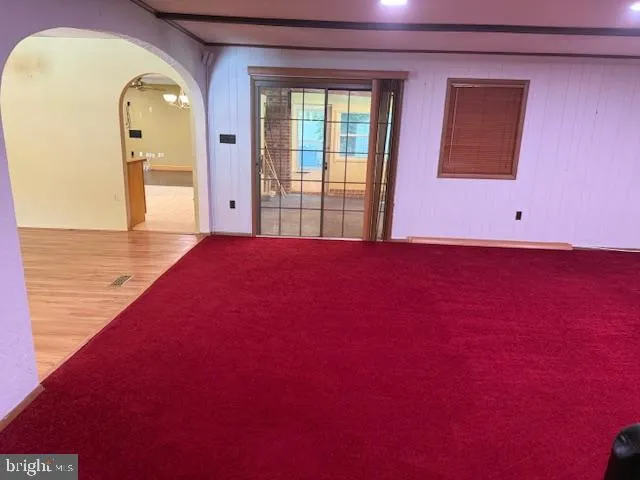 a living room with furniture and a pool table