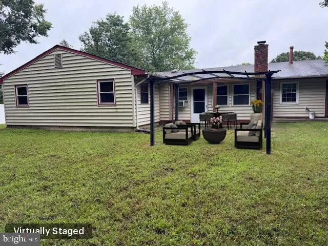 a view of a house with a backyard and a tree