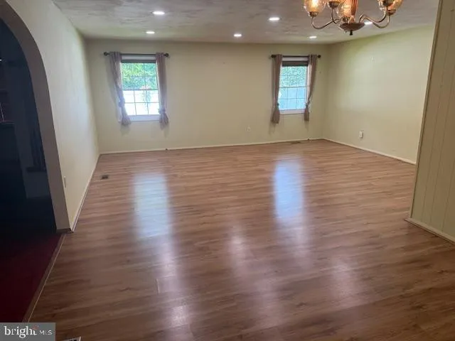 a view of a room with wooden floor and bench