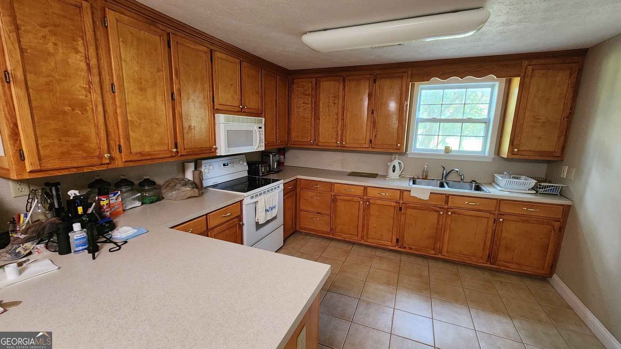 3176 East Centerpoint Road Preston, GA 31824 - Photo 9 of 44 a kitchen with sink a window and cabinets