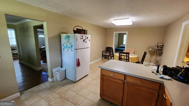 a kitchen with refrigerator and furniture