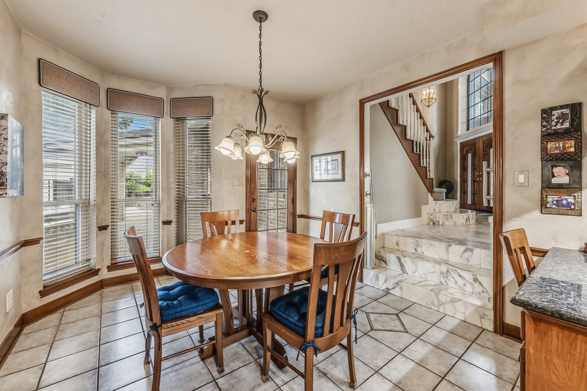 6047 Spring Creek Lane Spring, TX 77379 - Photo 19 of 50 Wrapped in windows and natural light, the breakfast room feels like a quiet corner of the home designed to ease into the day. The rounded dining space and nearby staircase create a setting that feels both open and comfortably connected to the heart of the home.