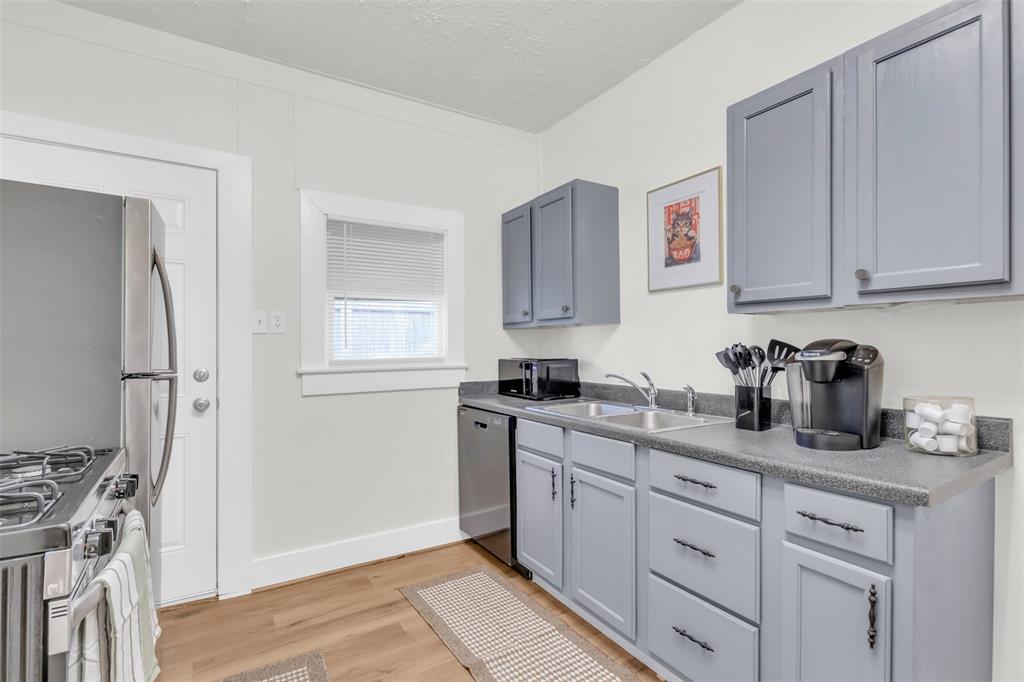 4121 Junius Street, Unit 4123 Dallas, TX 75246 - Photo 13 of 23 a kitchen with cabinets appliances and a window