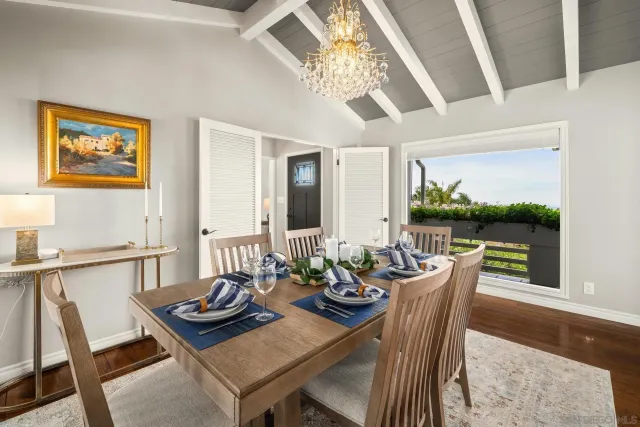 a view of a dining room with furniture a chandelier and wooden floor
