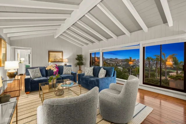 a living room with furniture and a floor to ceiling window