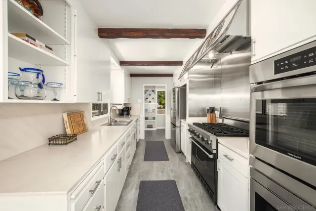 a bathroom with a granite countertop sink a toilet and mirror