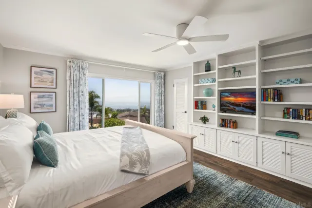a bedroom with a large bed and a chandelier