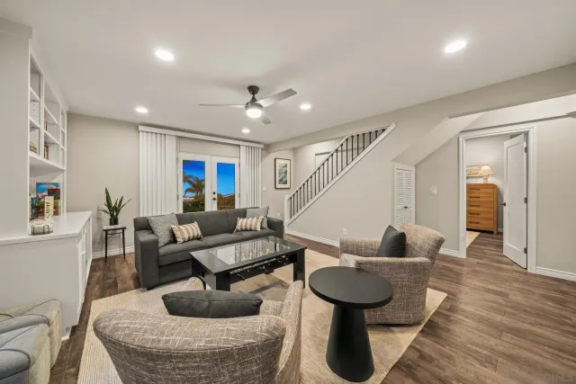 a view of a patio with couches table and chairs and potted plants