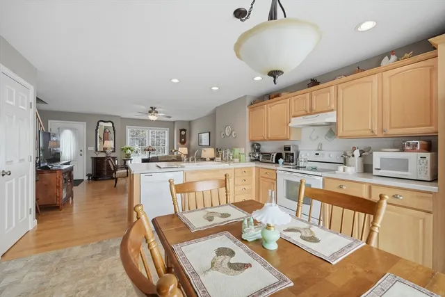 a large kitchen with kitchen island a stove a sink a dining table and chairs
